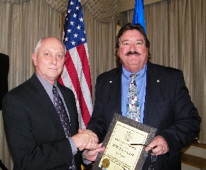Kelley (r) recognizes Irvine Eanes, Air Force Command and Control Integration Center, with an AFCEA Lifetime Member Award in November.